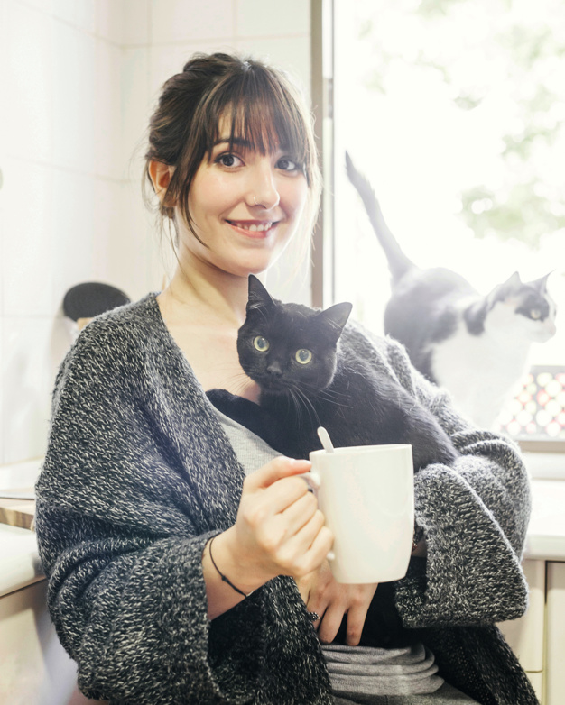 happy-woman-with-cup-coffee-holding-her-cat_23-2147860403.jpg